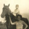 Ragazzino a cavallo con giovane